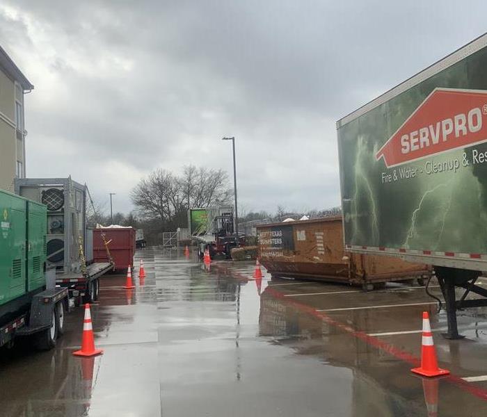 SERVPRO truck outside of a flooded building following a storm